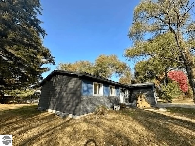 view of property exterior featuring a lawn