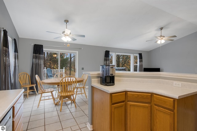 kitchen featuring light tile patterned flooring, dishwasher, plenty of natural light, and lofted ceiling