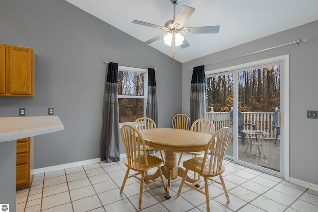 dining space featuring lofted ceiling, light tile patterned floors, ceiling fan, and plenty of natural light