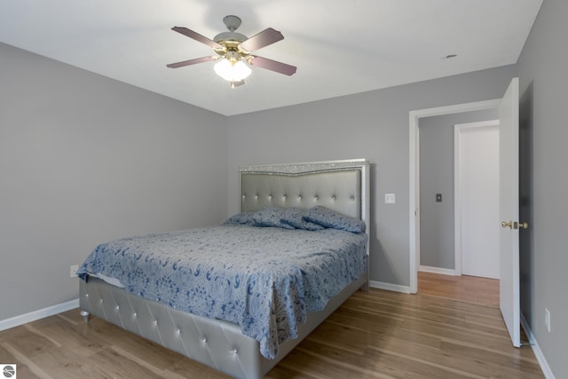 bedroom featuring light wood-type flooring and ceiling fan