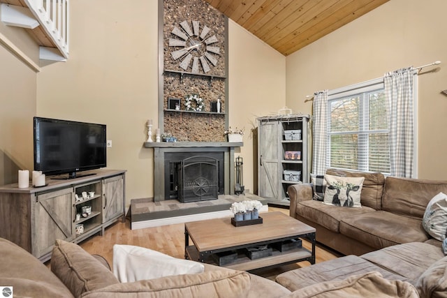 living room featuring wood ceiling, high vaulted ceiling, and light hardwood / wood-style flooring