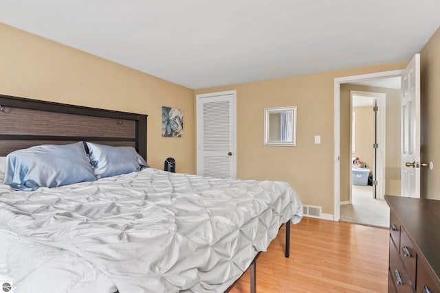 bedroom featuring light wood-type flooring and a closet