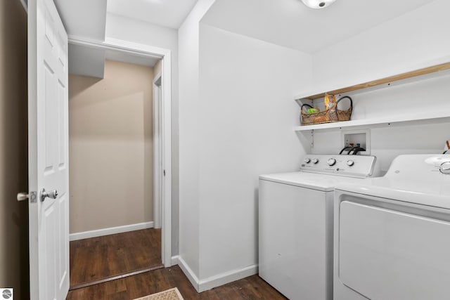 laundry room with washer and clothes dryer and dark wood-type flooring