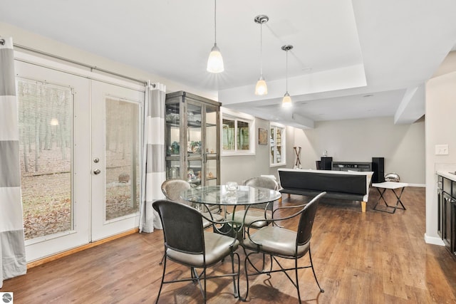 dining space with french doors and light hardwood / wood-style flooring