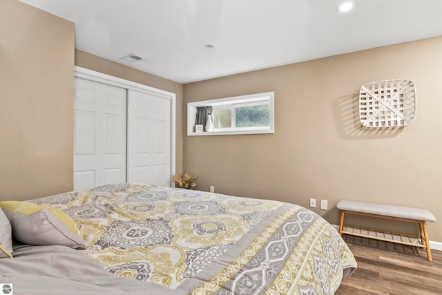 bedroom featuring hardwood / wood-style flooring and a closet