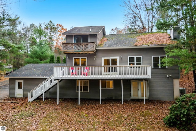 rear view of property featuring central air condition unit and a deck