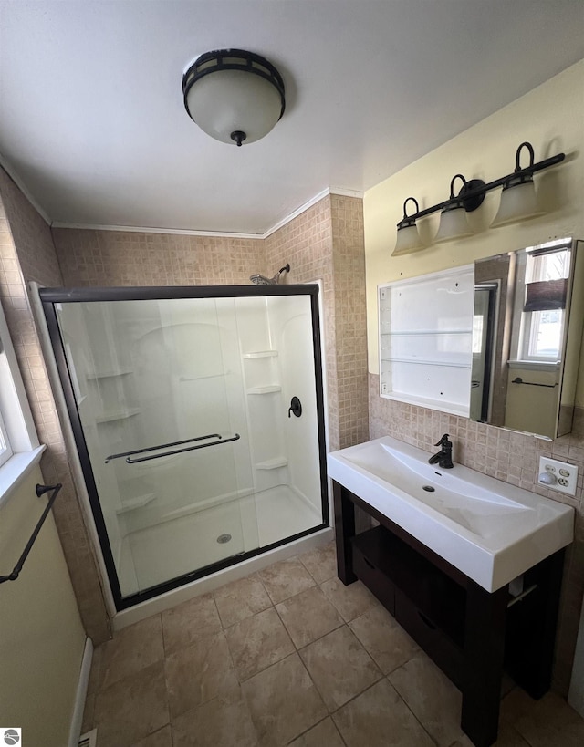 bathroom featuring tile patterned flooring, backsplash, and a shower with door