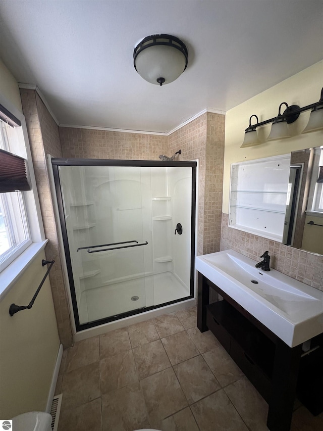 bathroom featuring decorative backsplash, tile patterned floors, and walk in shower