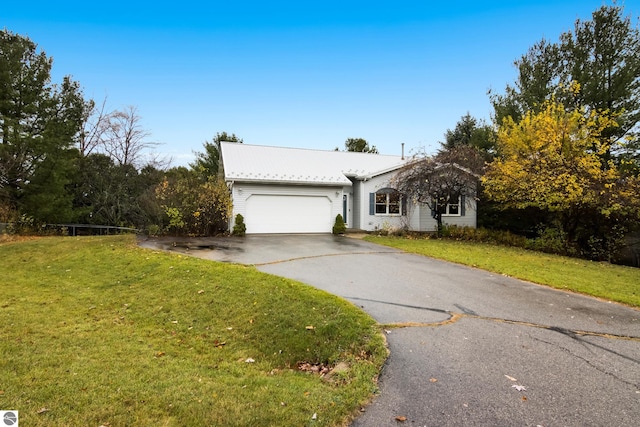 single story home with a garage and a front lawn