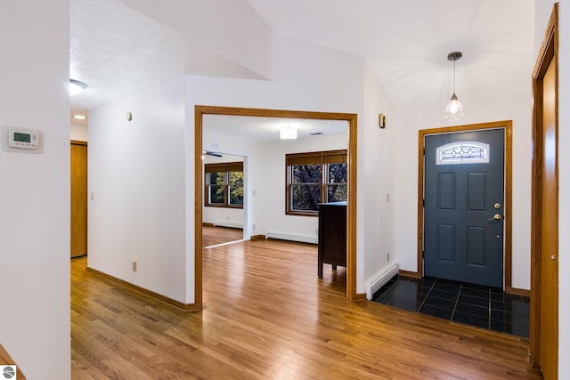 entryway featuring lofted ceiling, light wood-type flooring, and baseboard heating