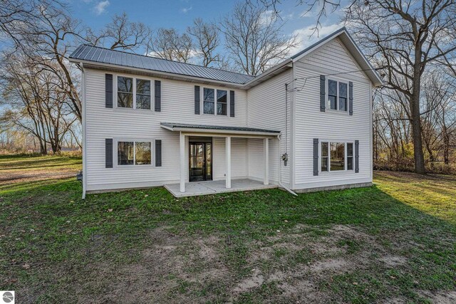 back of house with a yard and a patio area