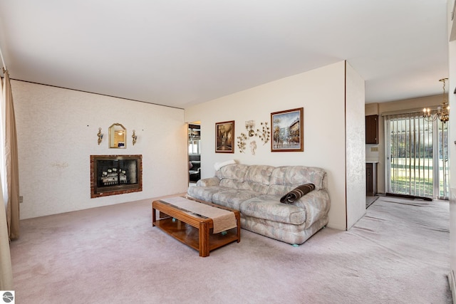 carpeted living room with a notable chandelier