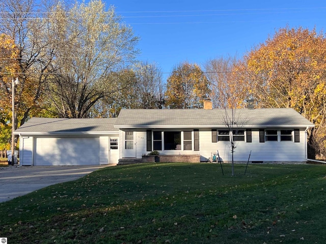 ranch-style home featuring a garage and a front lawn