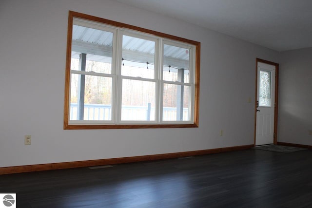 empty room with dark wood-type flooring