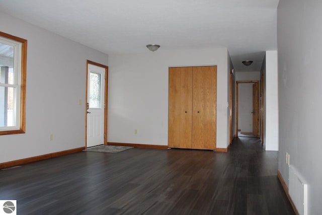 unfurnished room with dark wood-type flooring