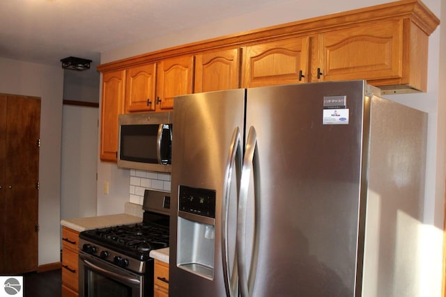 kitchen with tasteful backsplash and stainless steel appliances