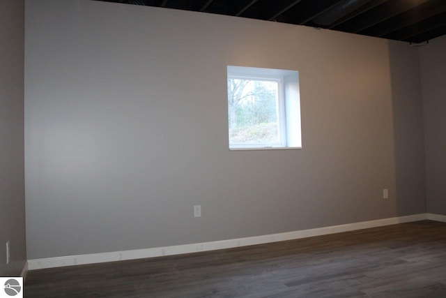 empty room featuring dark wood-type flooring