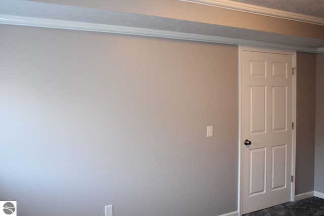 empty room featuring dark colored carpet