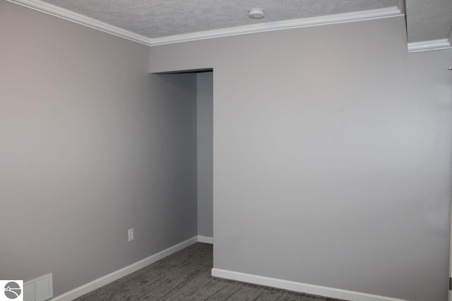 carpeted spare room with a textured ceiling and crown molding