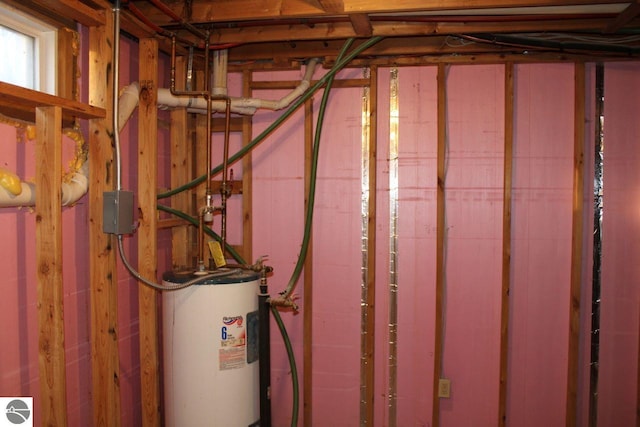 utility room featuring water heater