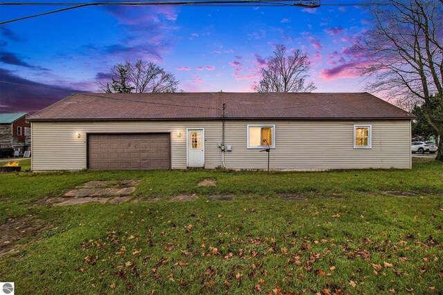 exterior space featuring a garage and a yard