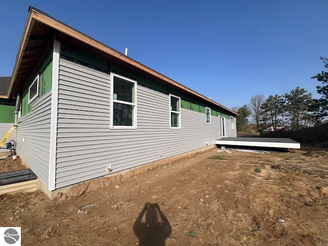 view of side of property featuring a wooden deck