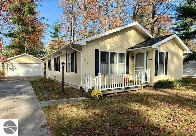 view of front of house with a garage and an outdoor structure