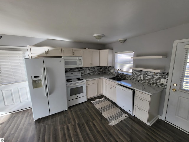 kitchen with white appliances, tasteful backsplash, white cabinetry, and sink