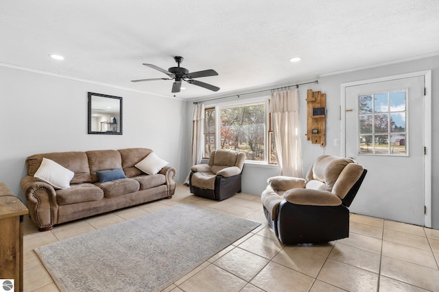 living room featuring ceiling fan, light tile patterned floors, and ornamental molding