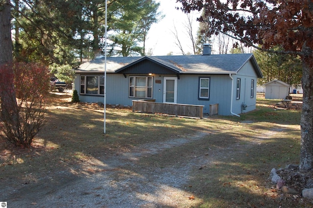 single story home featuring a storage shed