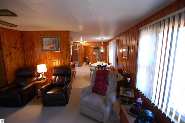 living room with a wealth of natural light and wooden walls