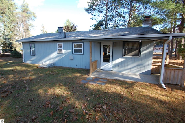 rear view of property featuring a yard