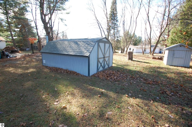 view of outdoor structure featuring a lawn