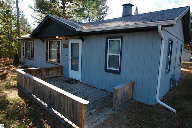 back of property with a wooden deck