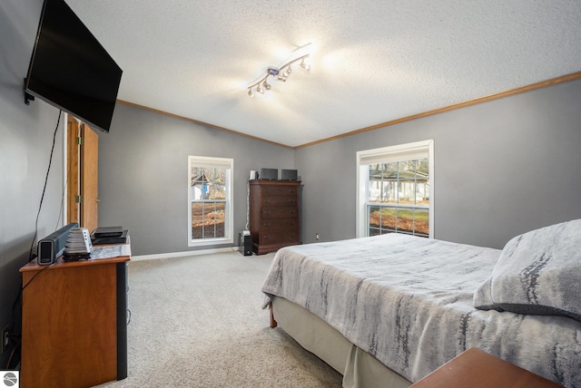 bedroom with crown molding, a textured ceiling, vaulted ceiling, and carpet floors