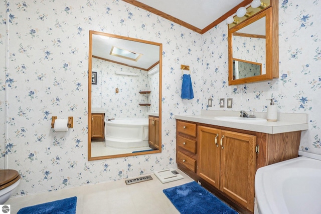 bathroom with vanity, toilet, a bathtub, and crown molding