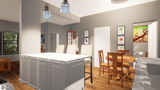 kitchen with gray cabinetry, wood-type flooring, and a kitchen island