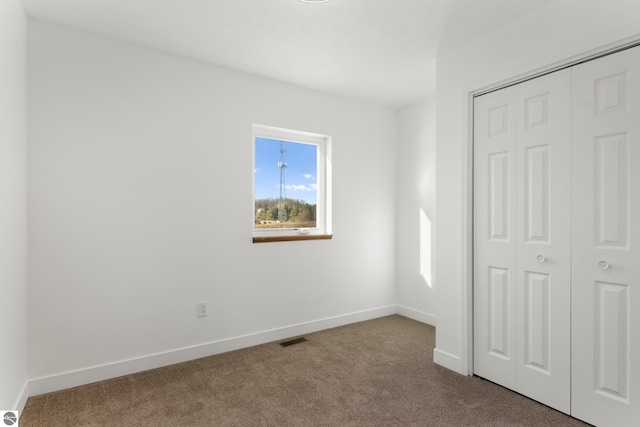 unfurnished bedroom featuring a closet and carpet