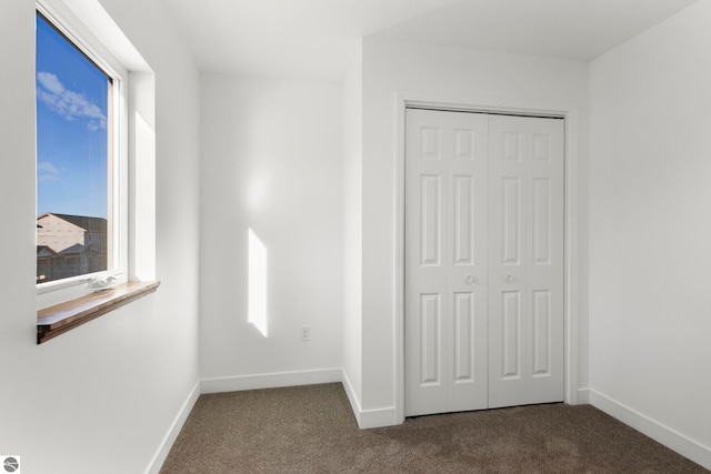 unfurnished bedroom featuring carpet floors and a closet