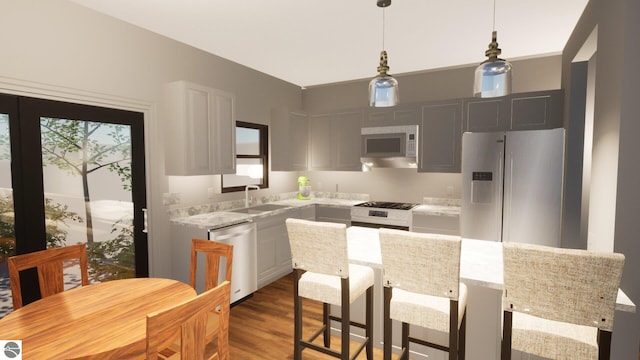 kitchen featuring sink, white cabinetry, stainless steel appliances, a kitchen island, and dark hardwood / wood-style flooring