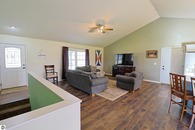 living room featuring dark wood-type flooring, ceiling fan, and vaulted ceiling