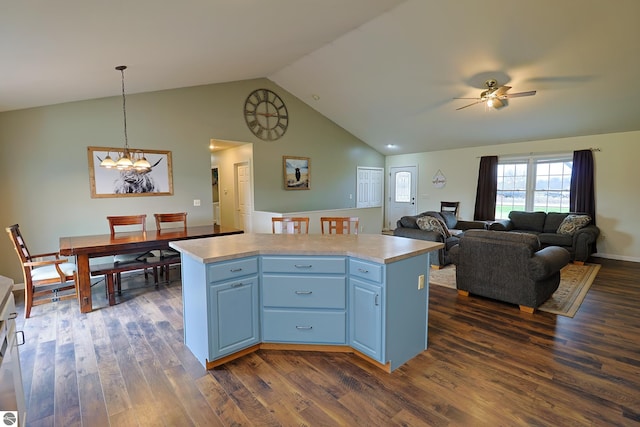 kitchen featuring hanging light fixtures, dark hardwood / wood-style floors, vaulted ceiling, and a center island