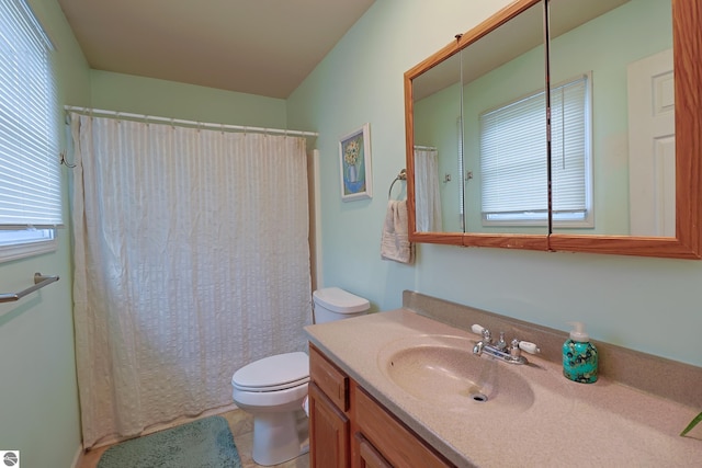 bathroom with tile patterned flooring, vanity, toilet, and a shower with shower curtain