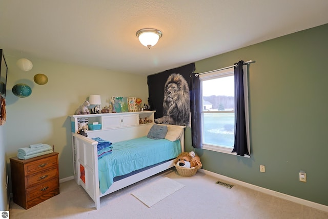 bedroom featuring light colored carpet