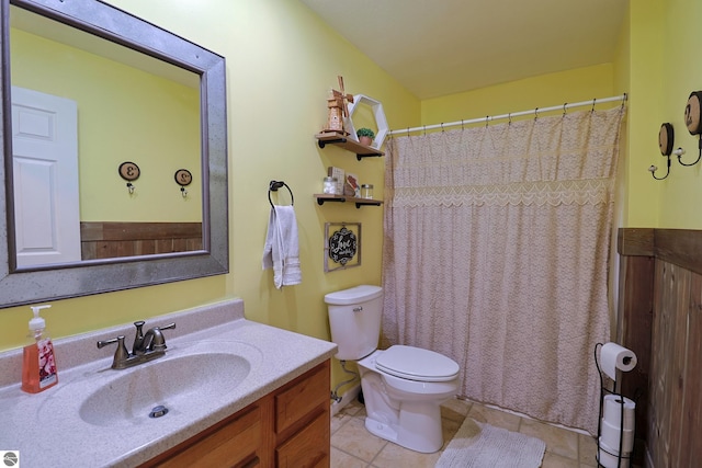 bathroom featuring tile patterned flooring, vanity, and toilet