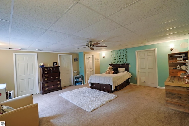 carpeted bedroom featuring a paneled ceiling and ceiling fan