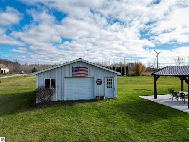 view of outdoor structure with a garage, a yard, and a gazebo