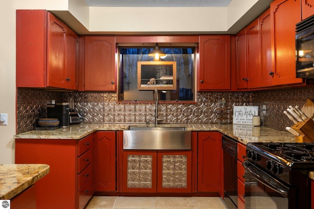 kitchen with black appliances, light tile patterned flooring, light stone countertops, decorative backsplash, and sink