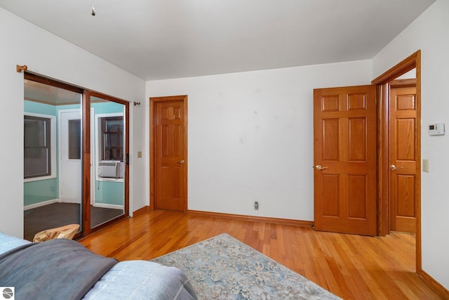 bedroom featuring light hardwood / wood-style flooring and cooling unit