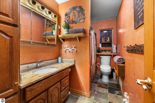 bathroom featuring toilet and vanity